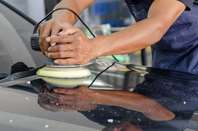 professional applying a ceramic coating to a vehicle