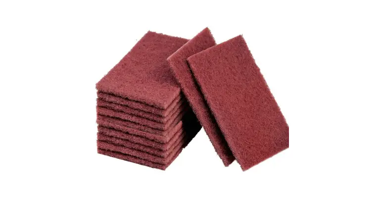 a stack of red scotch-brite type scouring pads that are used to remove rust