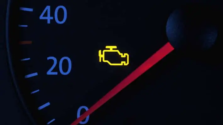 illuminated check engine light on a lit dashboard