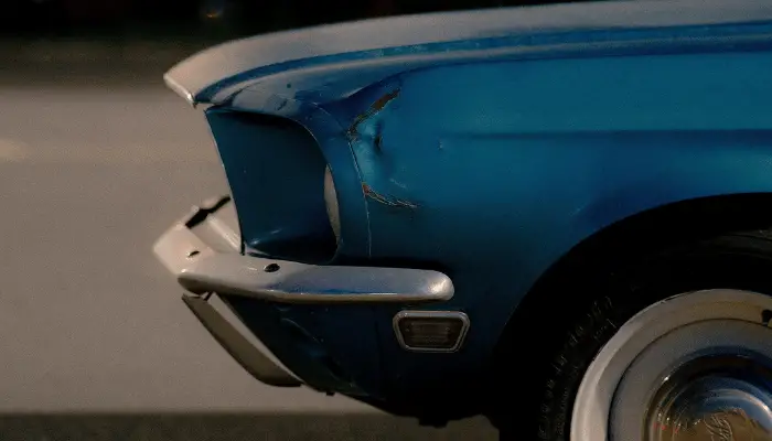 blue ford mustang in need of bumper repair