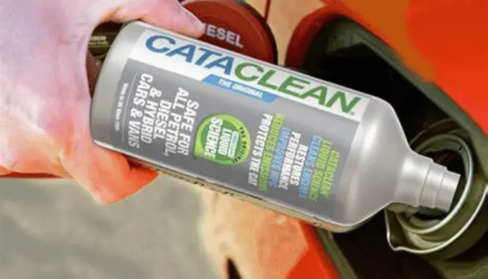 pouring cleaner into gas tank to clean catalytic converter