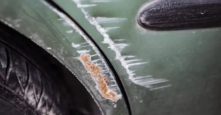 rusted car fender amongst other scratches to show what happens if you don't fix a key scratch