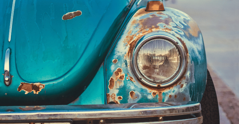 This is an example of clear coat that has faded around the headlights of a volkswagen beetle. Therefore, the rust has set in and ha begun to spread.