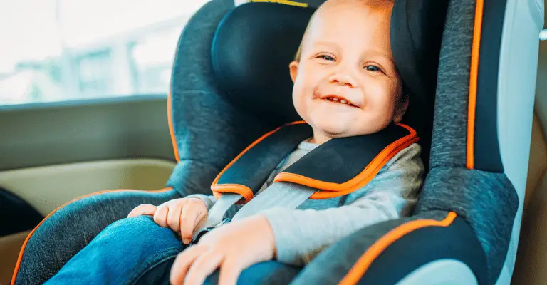 happy baby sitting in a well cooled car seat