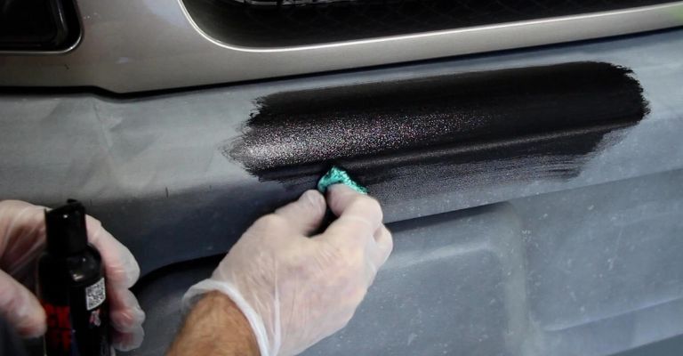 expert detailer showing how to restore plastic trim on a car